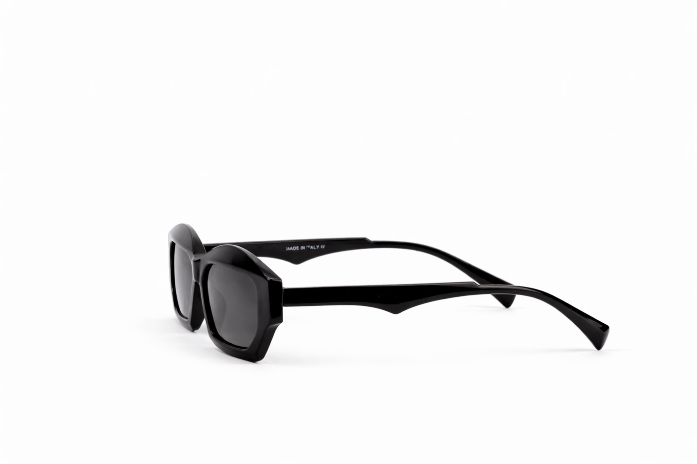 Black sunglasses with dark lenses on a white background