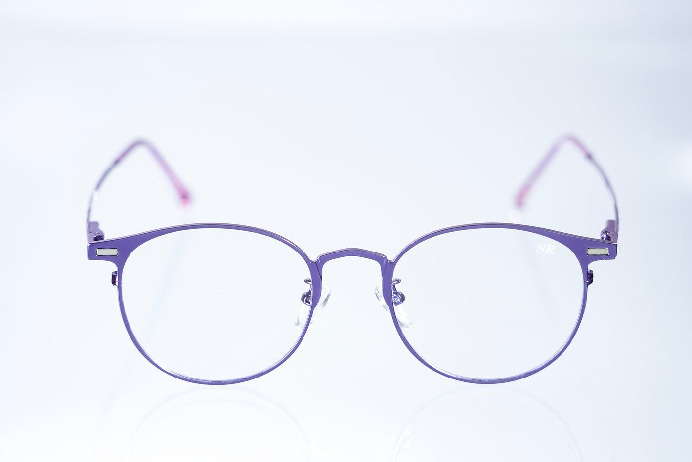 Purple eyeglasses on a light purple background