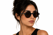 Minimalist round sunglasses with a matte black frame and warm brown lense